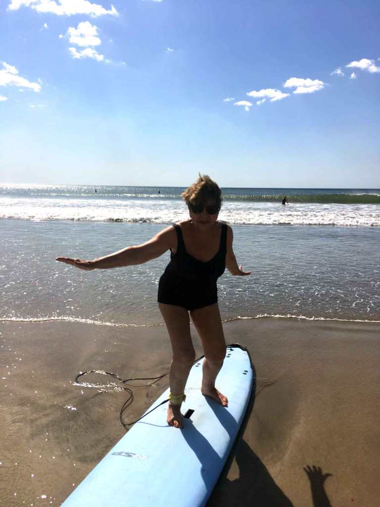 Hazel on surf board in Tamarindo, Costa Rica