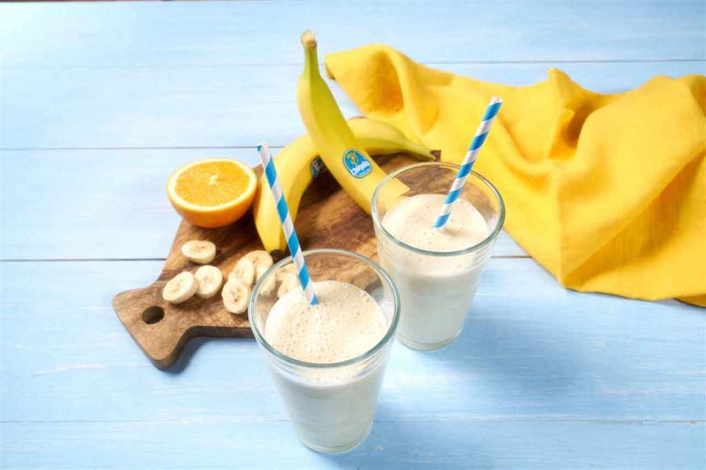 A table full of food such as cottage cheese and fresh fruit.