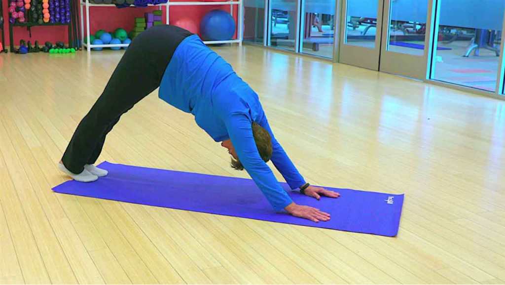 Man in gym executing a stretching exercise